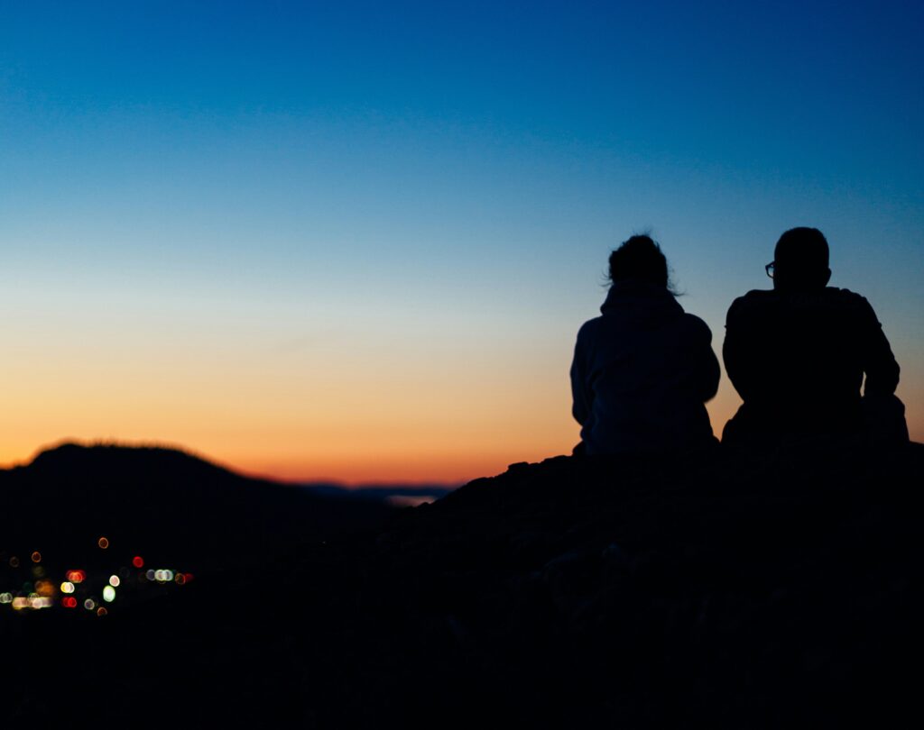 couples sitting on a mountain top